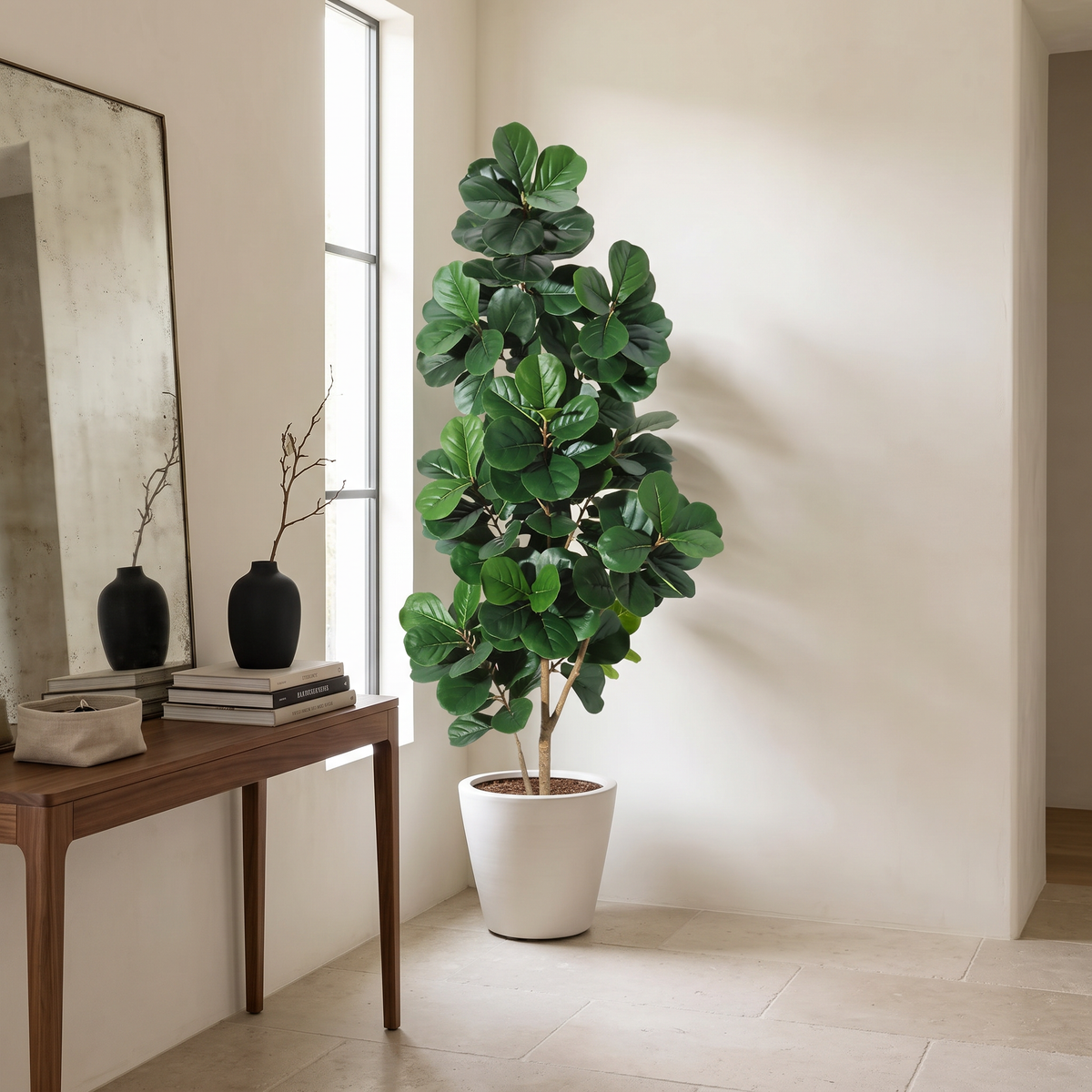 Artificial fiddle leaf fig tree in a white planter with a weighted base