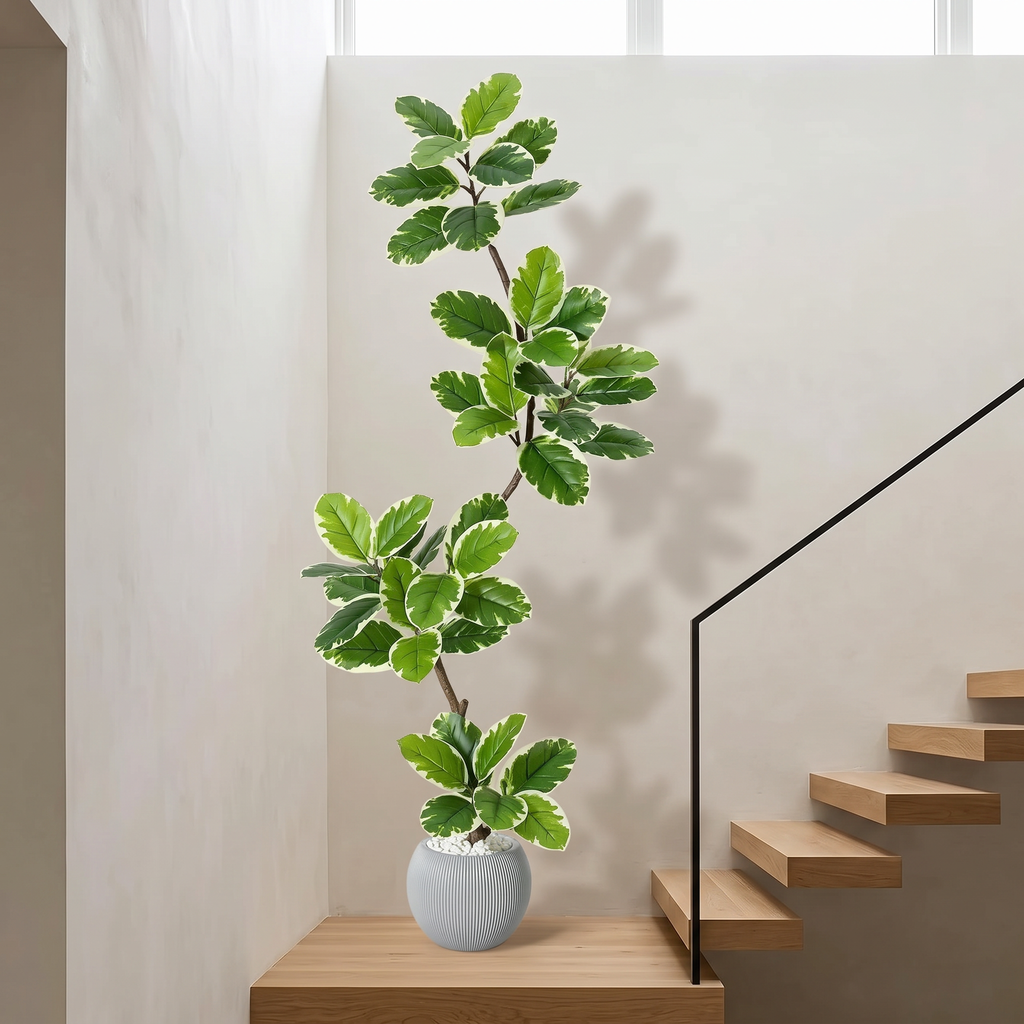 Artificial fiddle leaf fig tree in a gray sphere planter topped with moss
