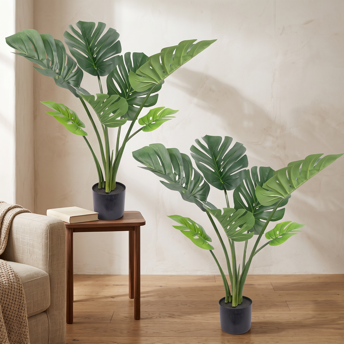 Artificial monstera deliciosa plant with large split leaves in a black pot