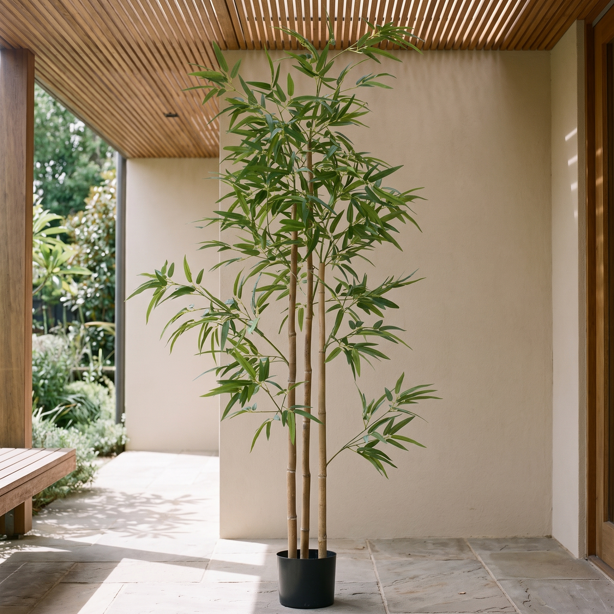 Artificial bamboo tree with dense foliage in a black nursery pot