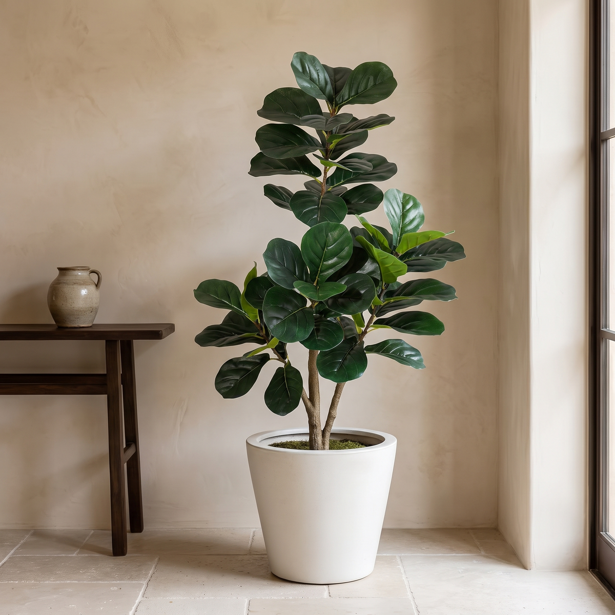 Artificial fiddle leaf fig tree in a weighted planter