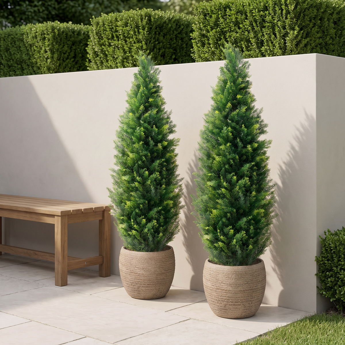 Artificial cedar topiary tree with a carbon steel trunk in a cement base