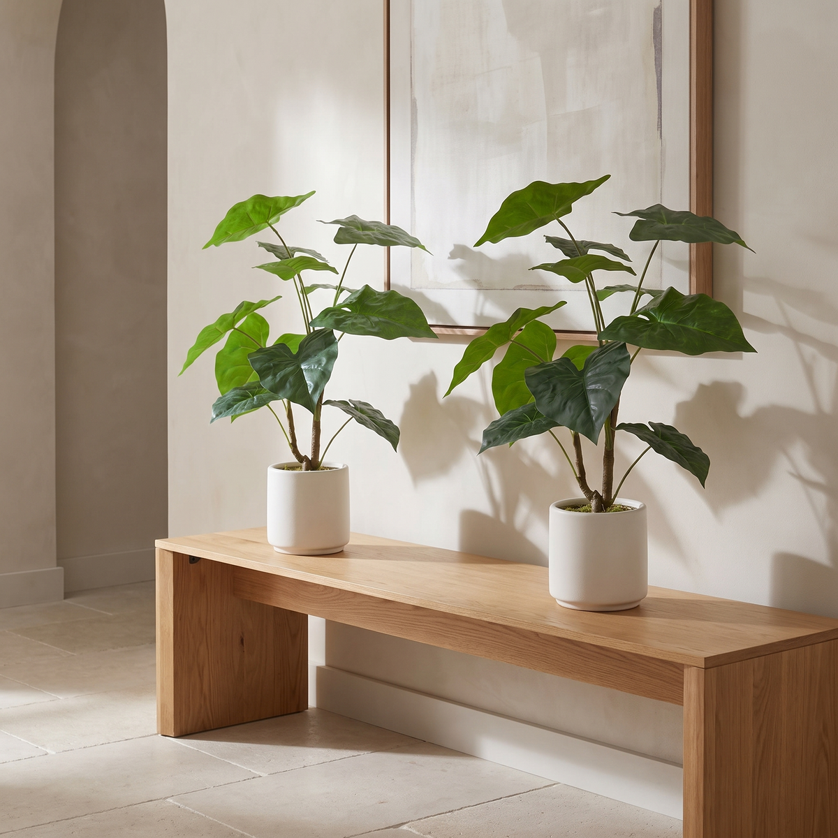 Pair of artificial Alocasia leaf plants in white pots
