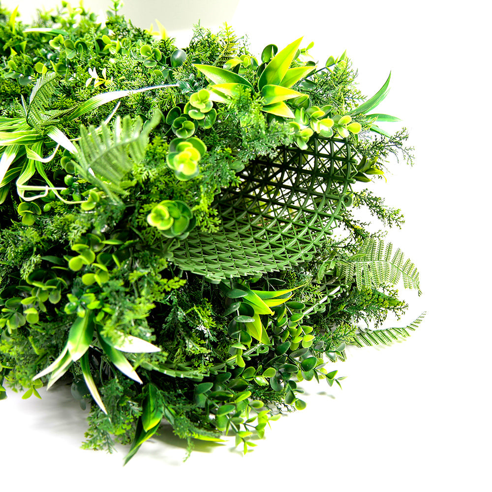 Vertical plant panels tiled into a full landscaped green wall in a commercial lobby