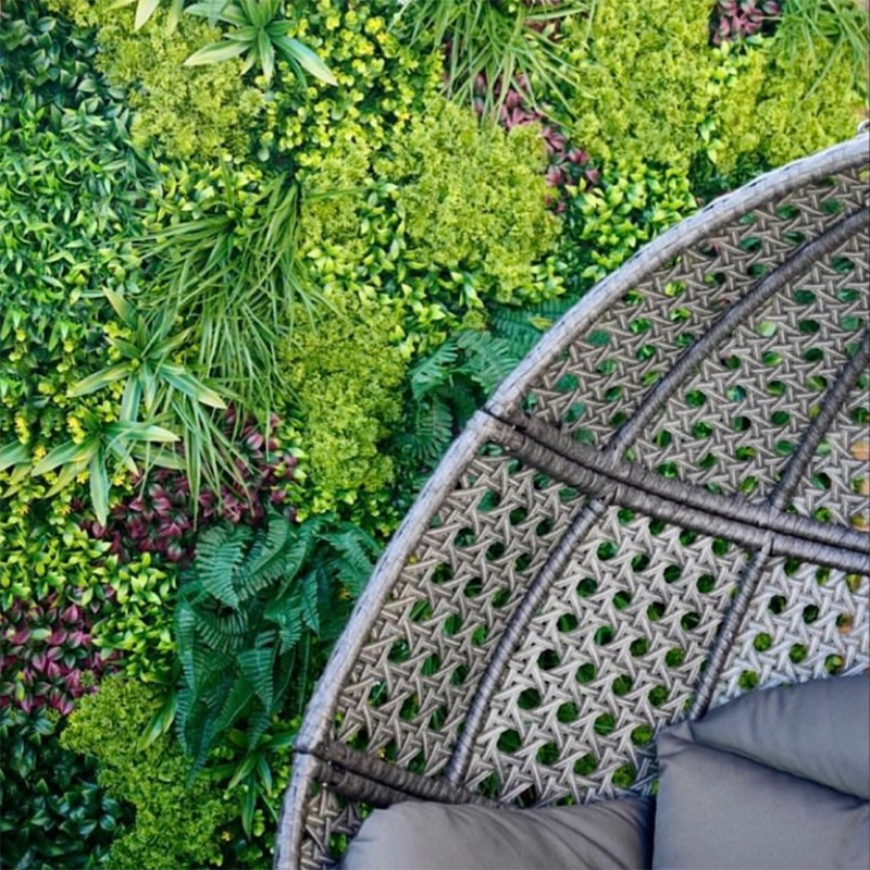 Boxwood plant wall panels tiled into a vertical garden wall in a hotel lobby